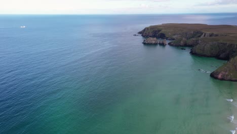 High-elevation-drone-shot-of-Traigh-Mhor-beach-with-cliffs-in-the-background-on-the-Outer-Hebrides-of-Scotland