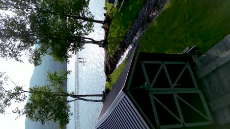 Drone-shot-of-a-couple-paddleboarding-nature-landscape-in-Lake-Elmore,-Vermont