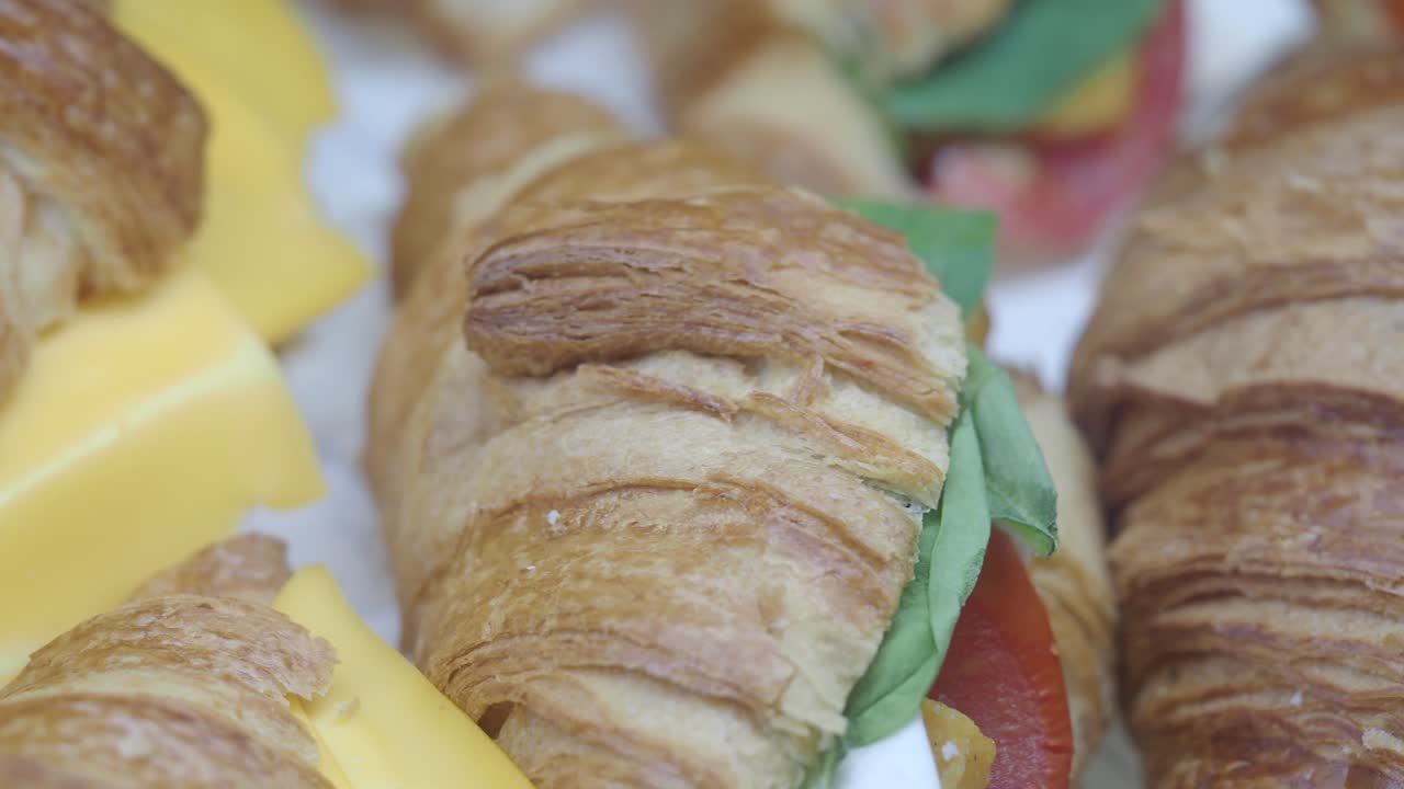 Close-up of gourmet croissant sandwiches and cheese