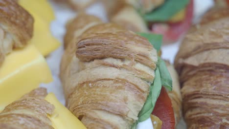 close-up of gourmet croissant sandwiches and cheese