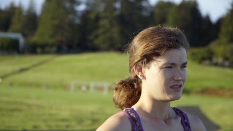 closeup slomo of young woman resting after a run at sunset