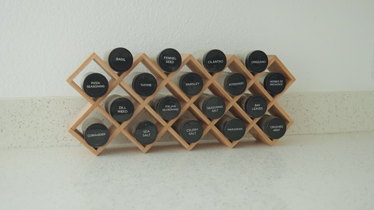 Spice rack with wooden shelf displaying various labeled spices, perfect for kitchen shots