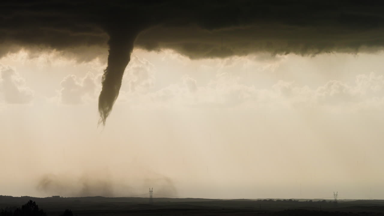 Twisting Tornado Touching Down on Flat Prairie During Storm
