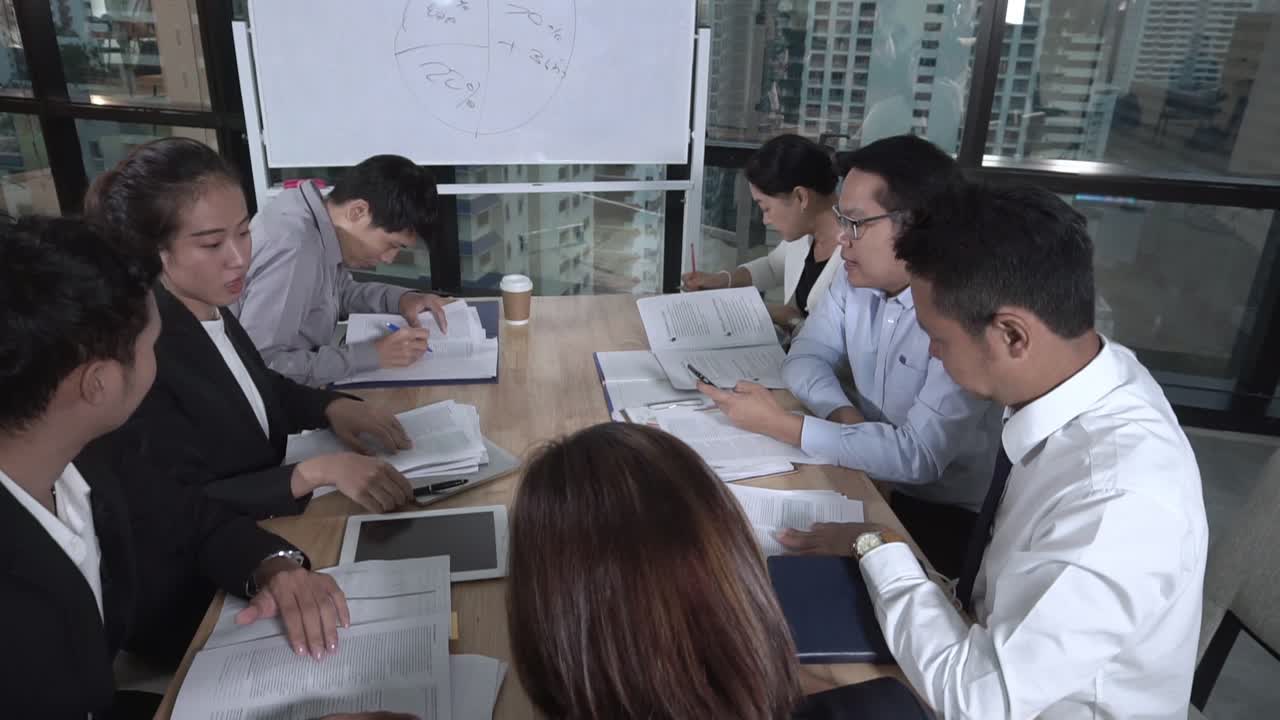 아시아 사업가들이 마케팅 전략을 논의하고 있습니다.