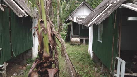 right-moving-trucking-shot-of-a-abandoned-derelict-destroyed-bungalow-beach-resort-from-the-effects-on-tourism-from-covid-19