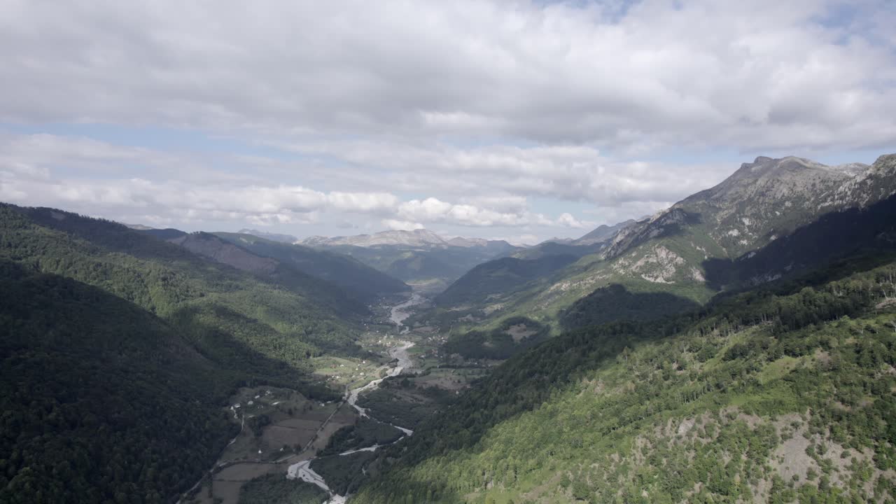 Drone video of frontal plane moving down over the Vermosh valley above the Vermoshi river, the sh20 at the height of Bashkimi, Albania