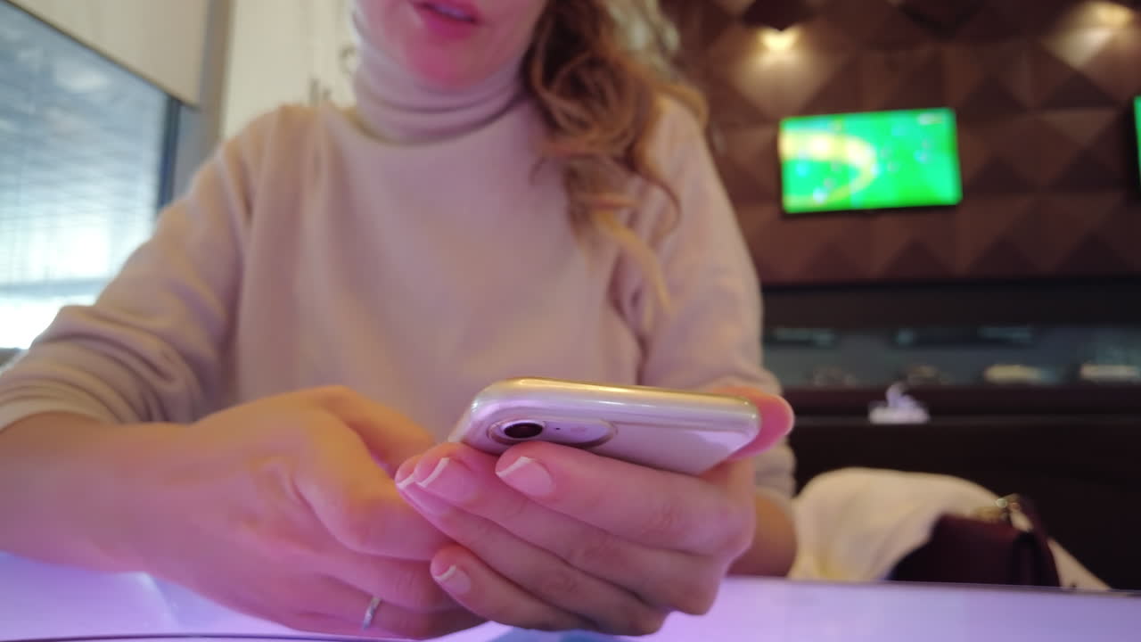 Woman working on mobile phone at a restaurant