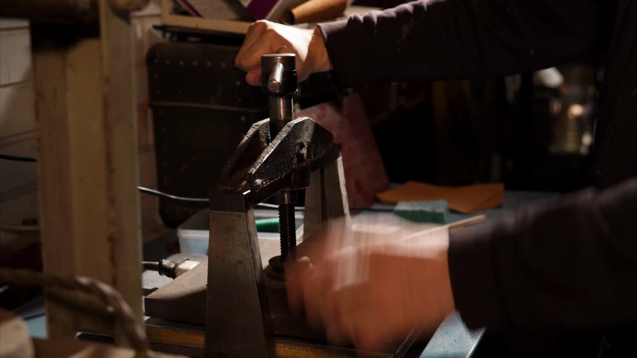 Person Operating a Vintage Metal Press