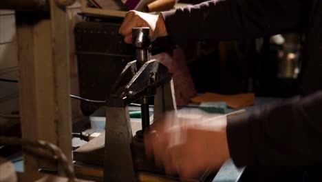 person operating a vintage metal press