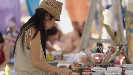 woman mixing paints at an art workshop