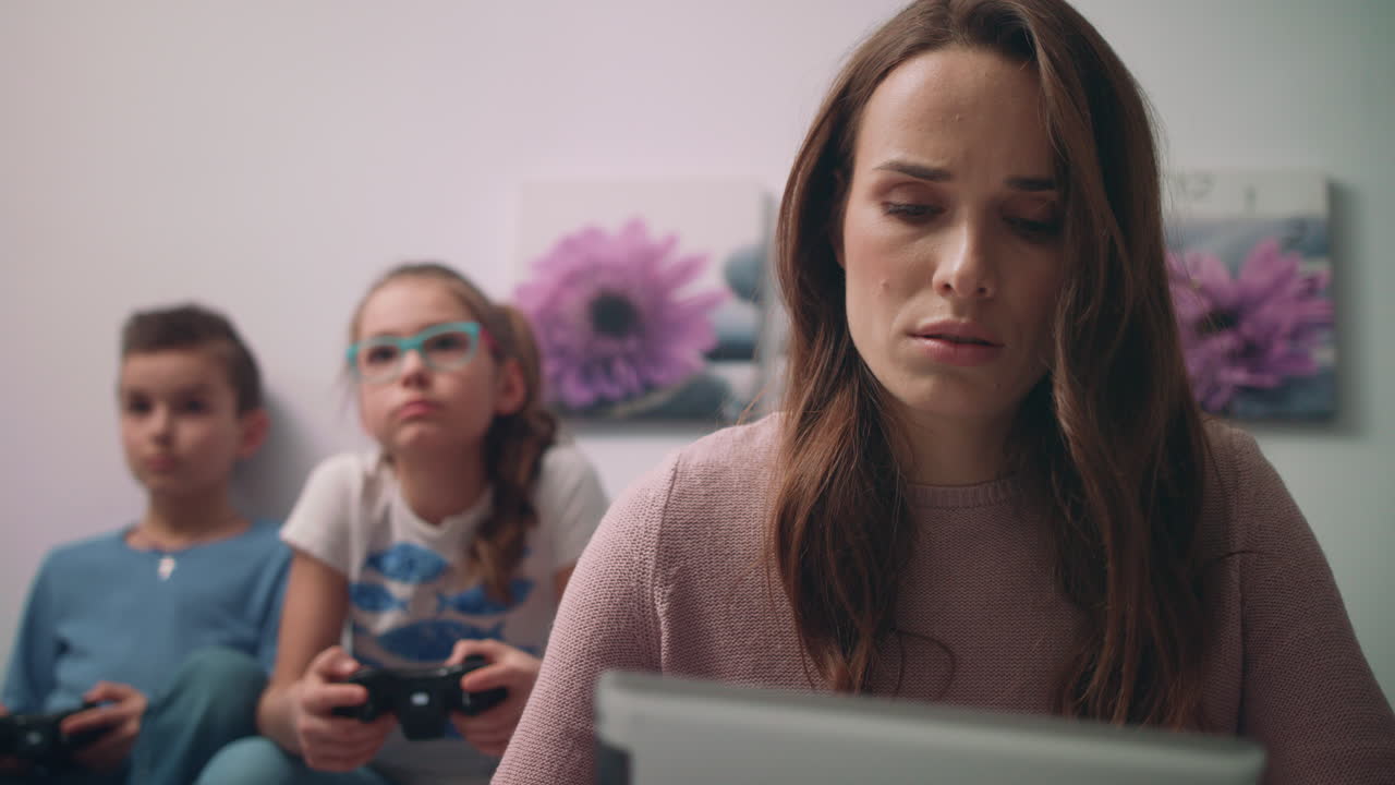 Worried woman looking tablet pc at home. Worried mother emotion