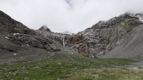 Waterfall-in-background-and-landscape-of-Fellaria-glacier-location-of-Valmalenco-in-Italy