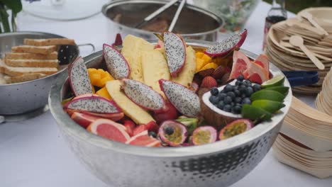 wide shot of a tropical salad bowl with dragon fruits, passion fruits, coconut