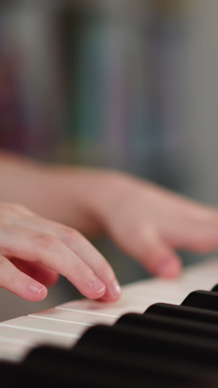 Child hands play piano. Young female student engages in music lesson in light premise. Talented kid improves technique of playing notes with different duration closeup