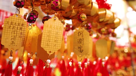 hanging golden bells with red tassels sway gently