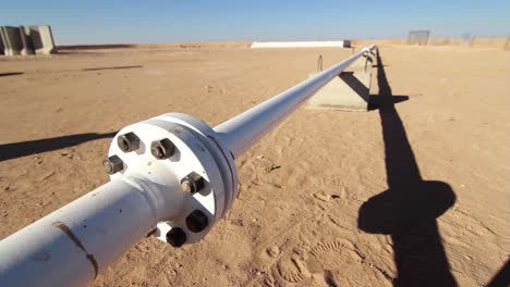 crude oil pipe in the desert with small pan day