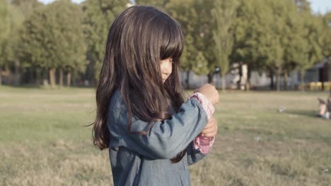 funny latin girl blowing bubbles and turning around in the park