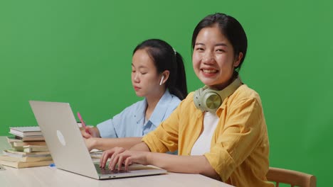 two students studying with a laptop