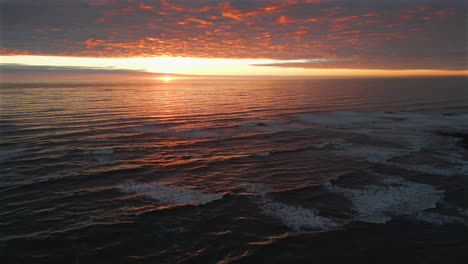 pullback establishing aerial drone shot of sea and beach at stunning sunrise at cleveland way in north yorkshire