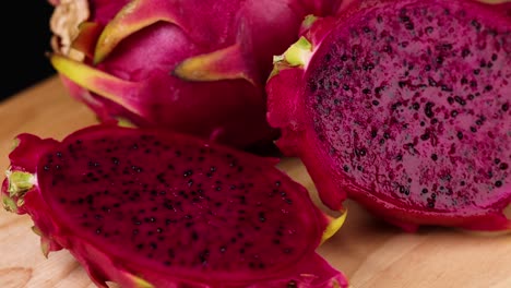 sliced dragon fruit displayed on wooden board