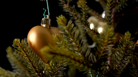 thoughtful christmas decor heart and bell hanging on a tree, sliding shot