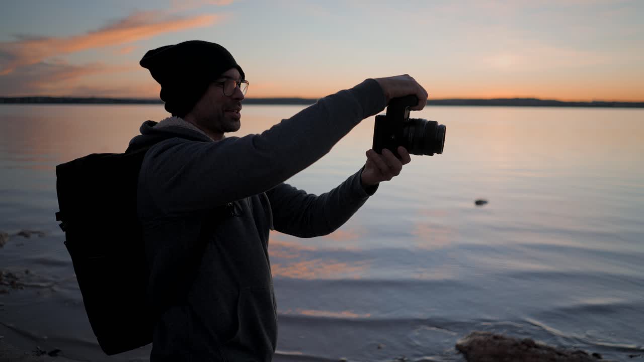 Photographer taking pictures at sunset on a lake