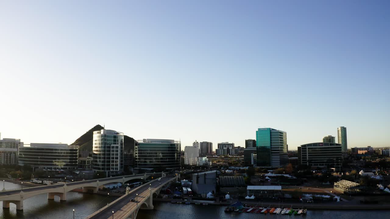 Shot tilting down to reveal an empty Tempe Bridge in Arizona's early morning glow
