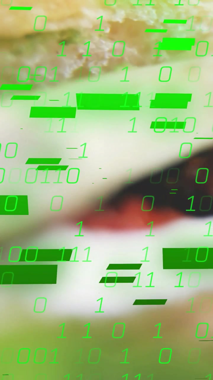 Vertical video: Camera shifting up focusing burger sharpening as green code overlaying for foodtech