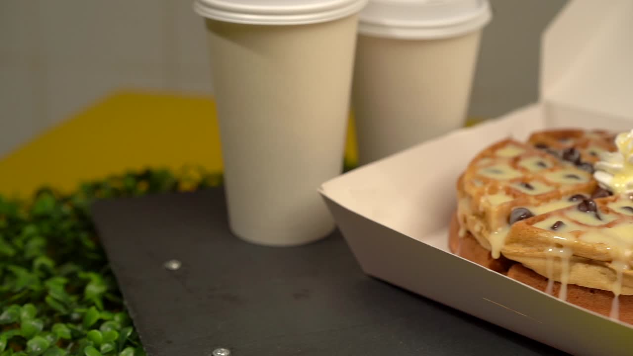 Chocolate chips and sweet cream waffles coffee slow motion panning