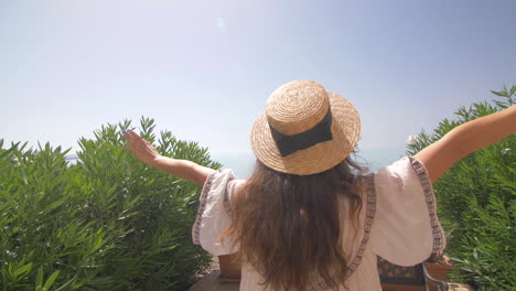 woman in a straw hat enjoying the beach