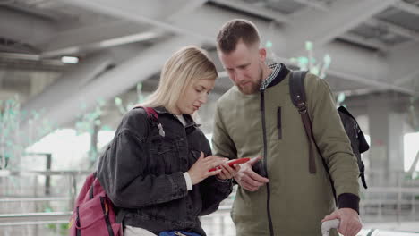 couple using smartphone at the airport