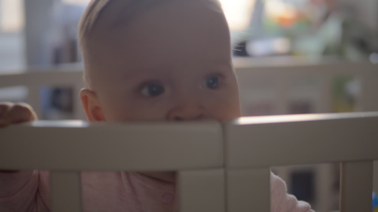 Cute baby girl in a round crib 10