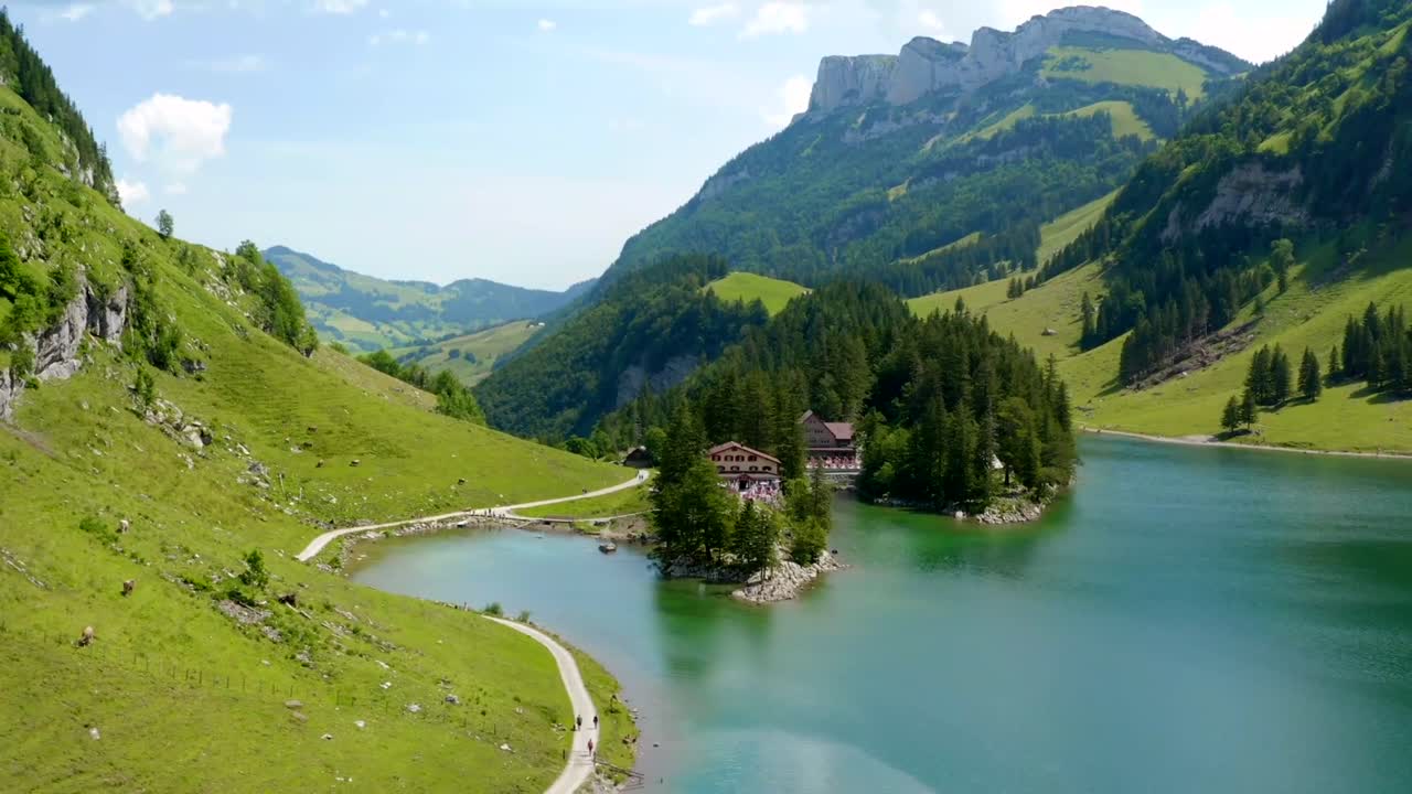 Scenic mountain lake with charming house in summer landscape