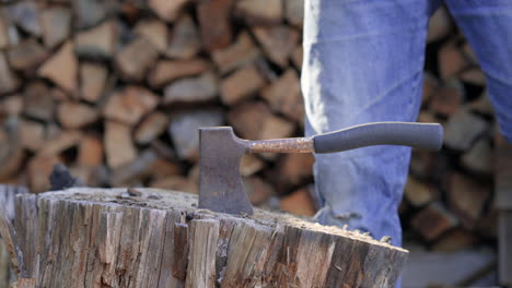 Man-Pulls-out-an-Axe-from-a-Stump