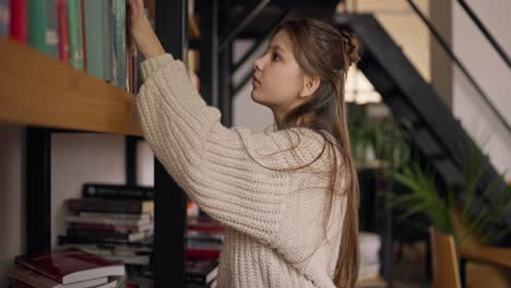 teenage girl reading in a cozy home library