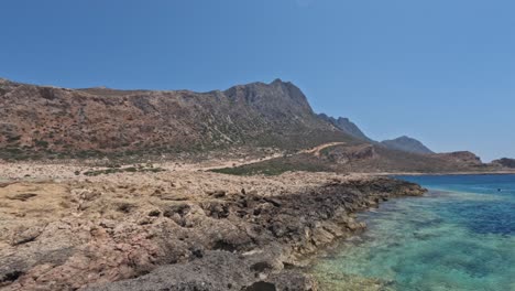 rocky shores with turquoise waters at balos beach in chania, crete, greece. aerial wide shot