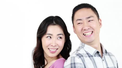 smiling couple showing their thumbs at the camera