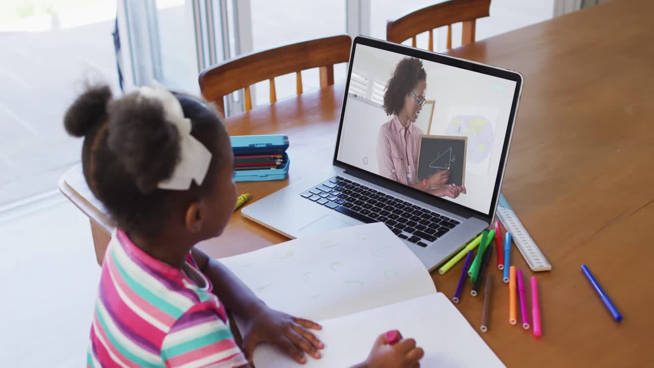 African american girl sitting at desk using laptop having online school lesson