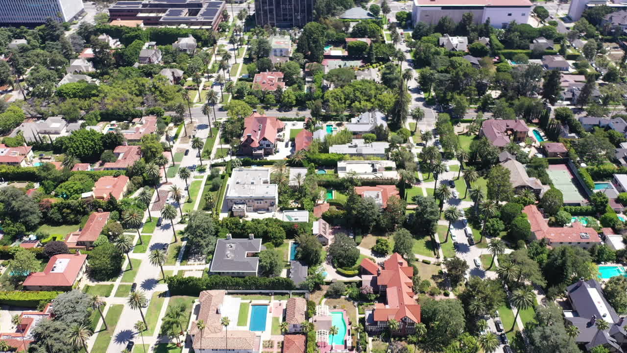 disparo de drones volando sobre el hermoso barrio de west hollywood, los ángeles, california, lleno de calles bordeadas de palmeras, autos, mansiones y piscinas