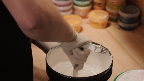 a worker open bucket the paint for painting the walls