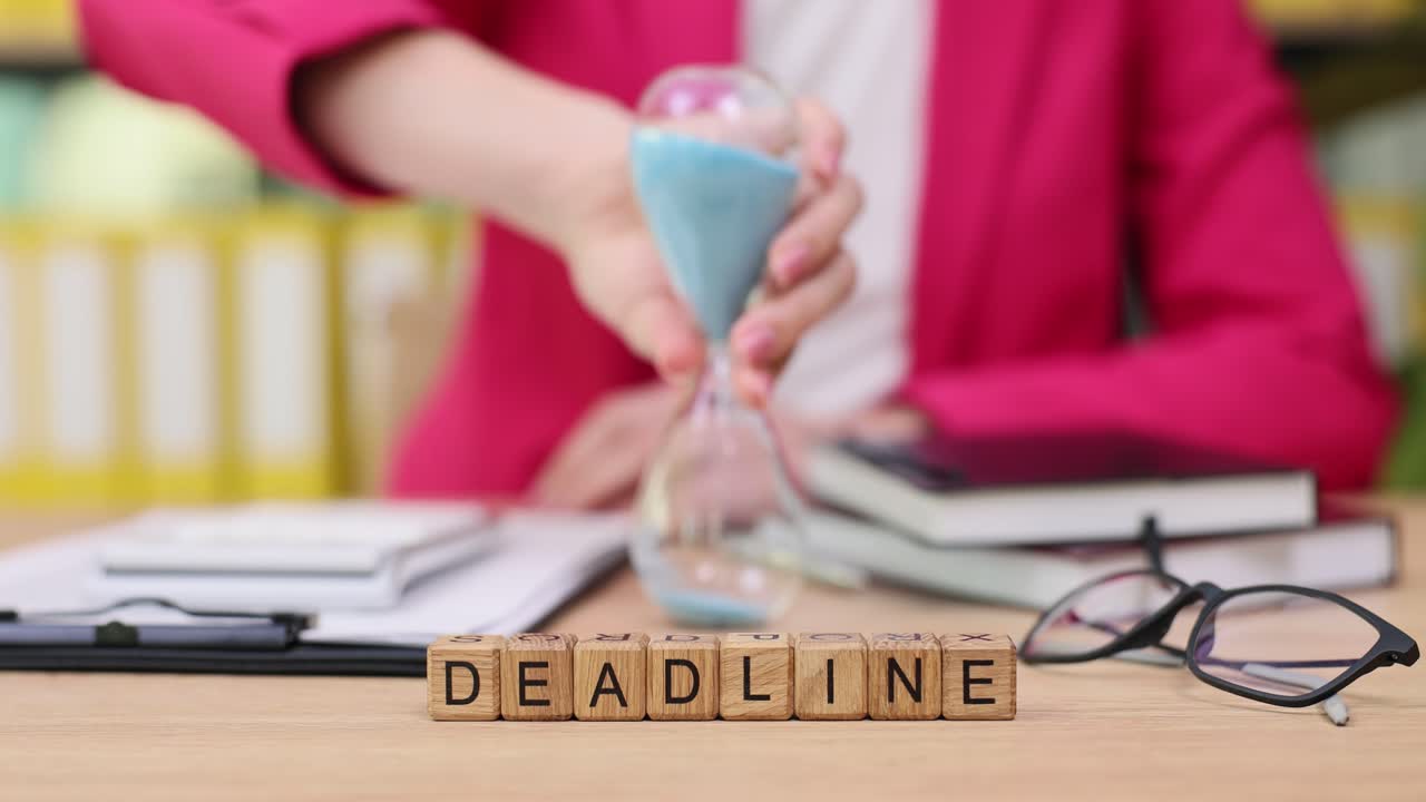 Deadline concept with hourglass and wooden blocks