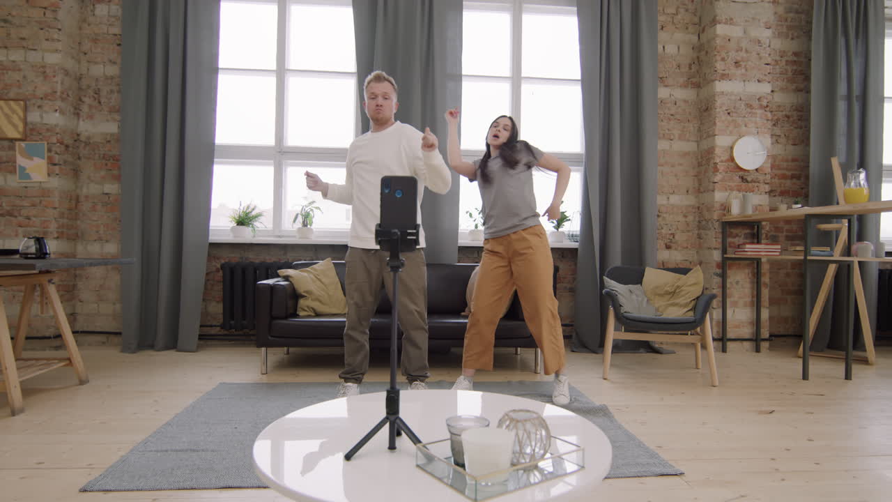 Man and Woman Filming Dance Challenge for Social Media