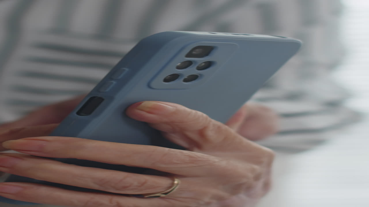 Hands of Aged Person Using Smartphone