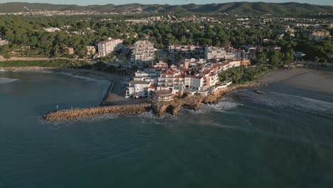 roc sant gaietà village on costa dorada during sunrise, calm sea, aerial view