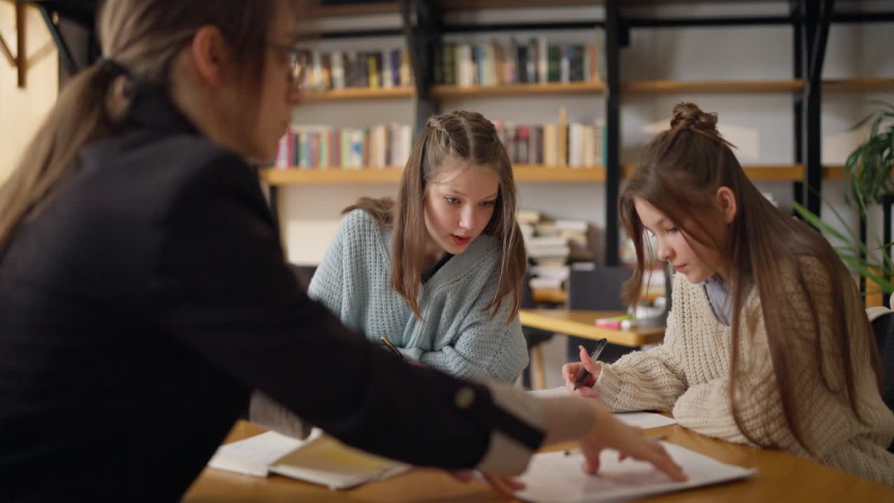 Teacher Assisting Students in a Study Session