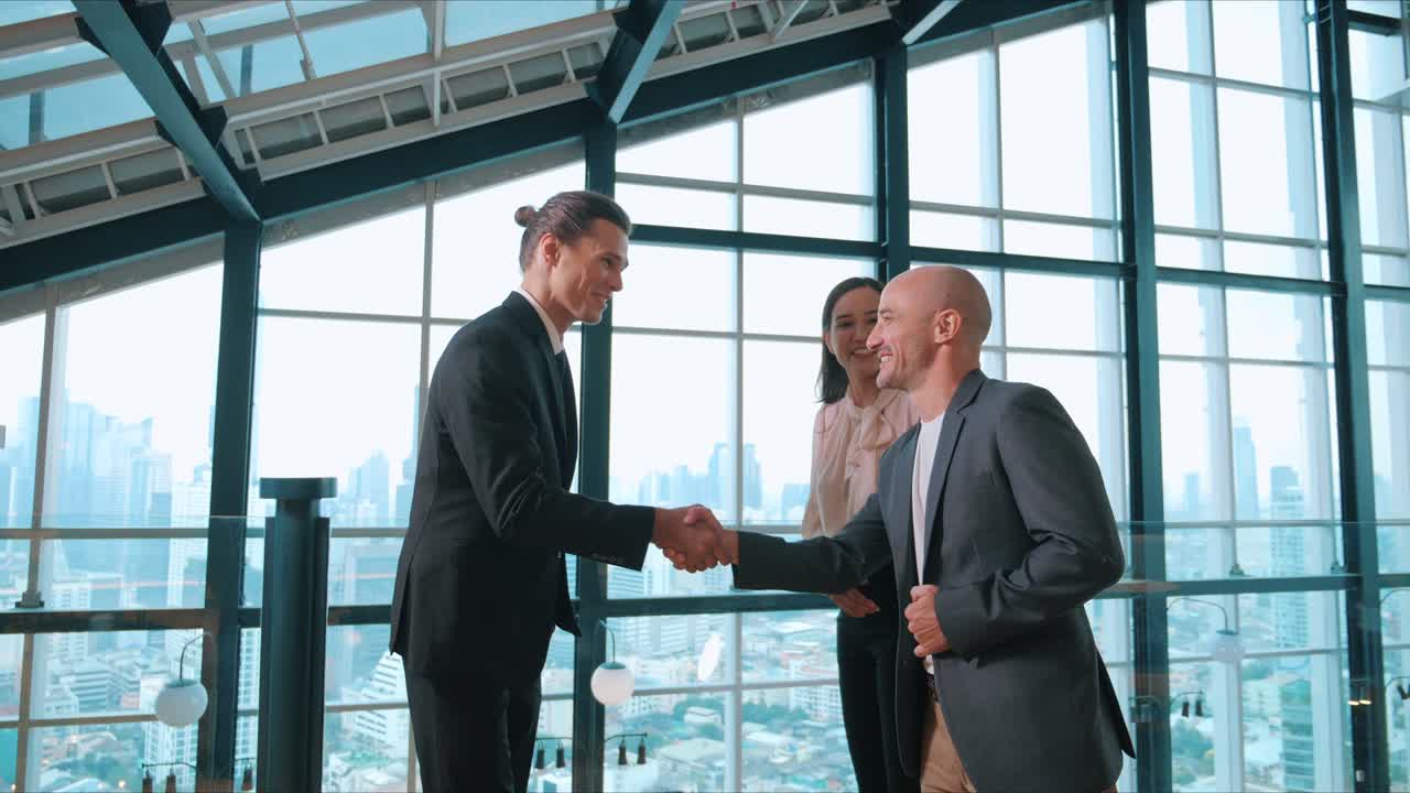 A group of business diverse people shaking hands and excited to work collaboratively with office building background in airport