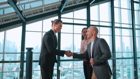 a group of business diverse people shaking hands and excited to work collaboratively with office building background in airport