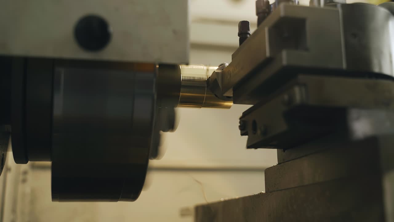 도자기 작업의 클로즈업: 절단기는 부품에서 금속 층을 제거합니다. 스핀들 회전