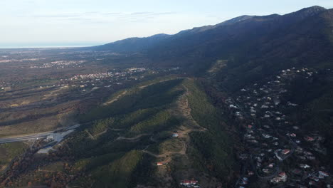 aerial view of a mountain landscape with a valley and coastline