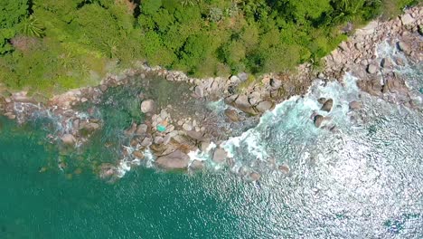 aerial view of tropical coastline with waves and rocks